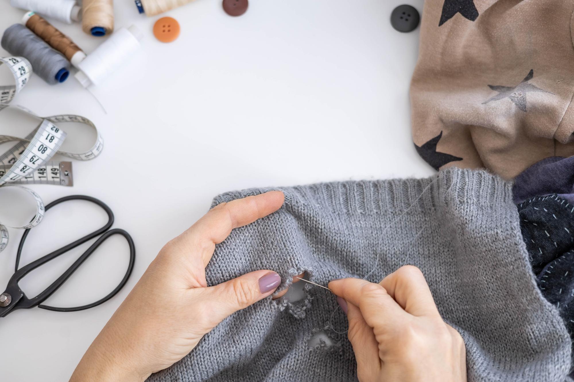 Workshop hands stitching a motif